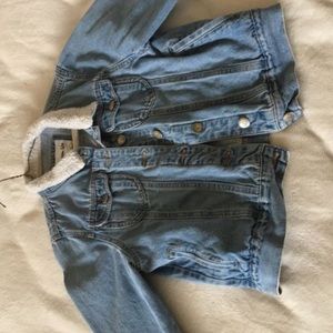 Denim jacket with white fur in the collar